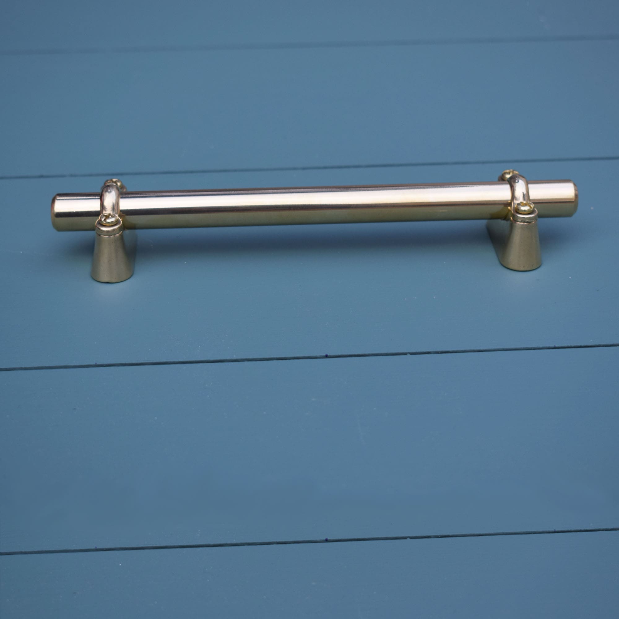 Solid Brass Bar Pull with Solid Brass Extenders on blue drawers