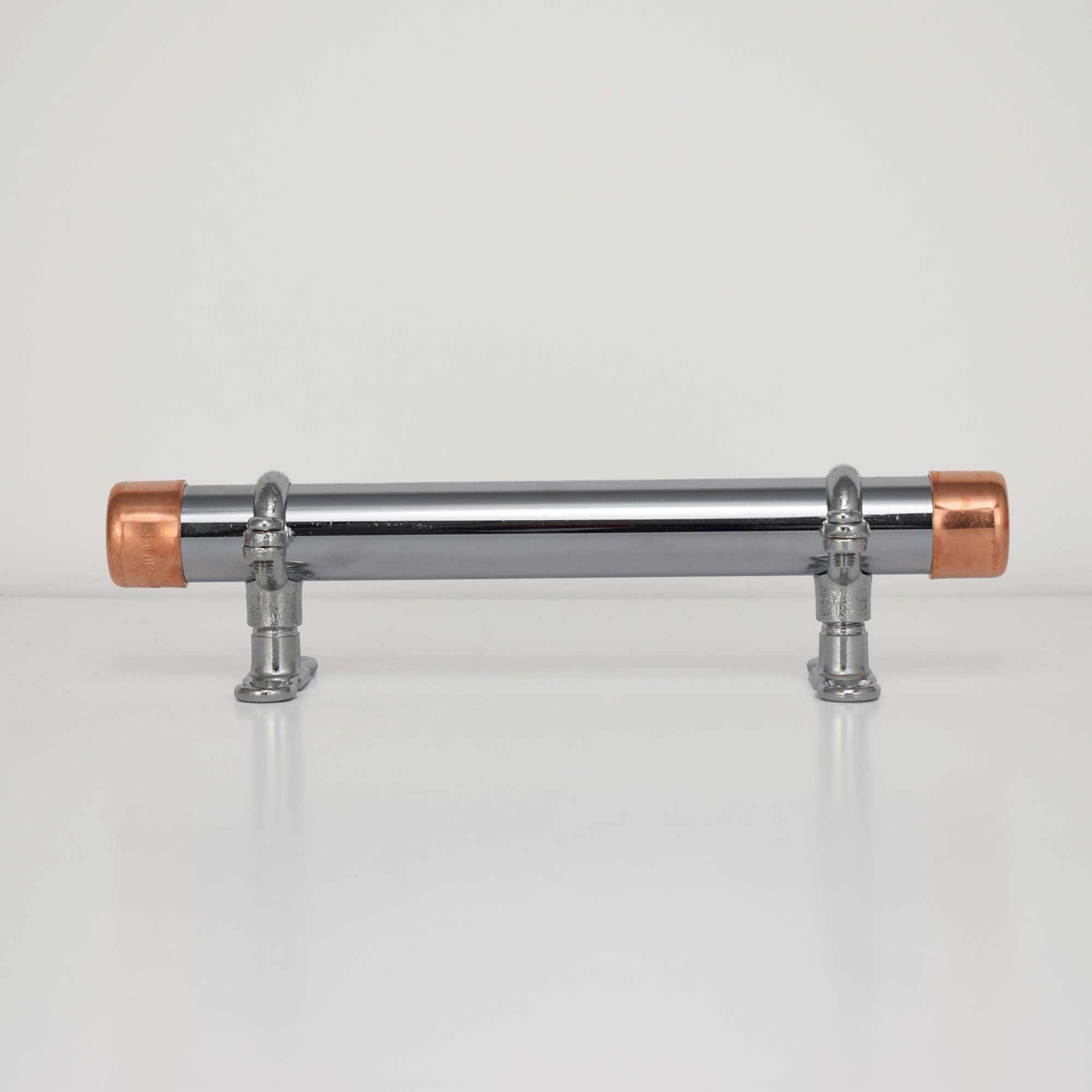 chrome and copper pull with chrome brackets on plain background