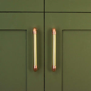 Brass U-Pull Handle with Copper Detail - Front Shot on Green Cabinet