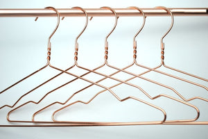 Five copper clothes hangers