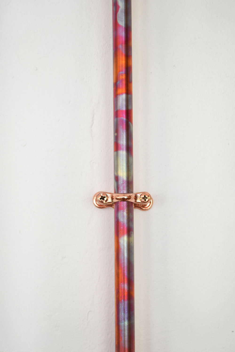 Close up of the unique colorful patina on the Marbled Copper Mixer Shower Marblista.