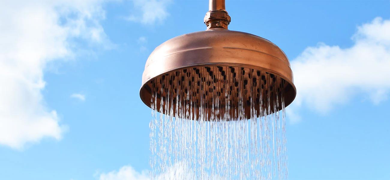 copper shower running outside on summers day 