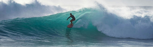 surfing a wave before outddor shower