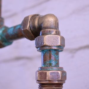 Rust-covered metal pipe fitting on a blurred background