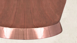 Close-up of a copper-colored metal surface with a textured finish.