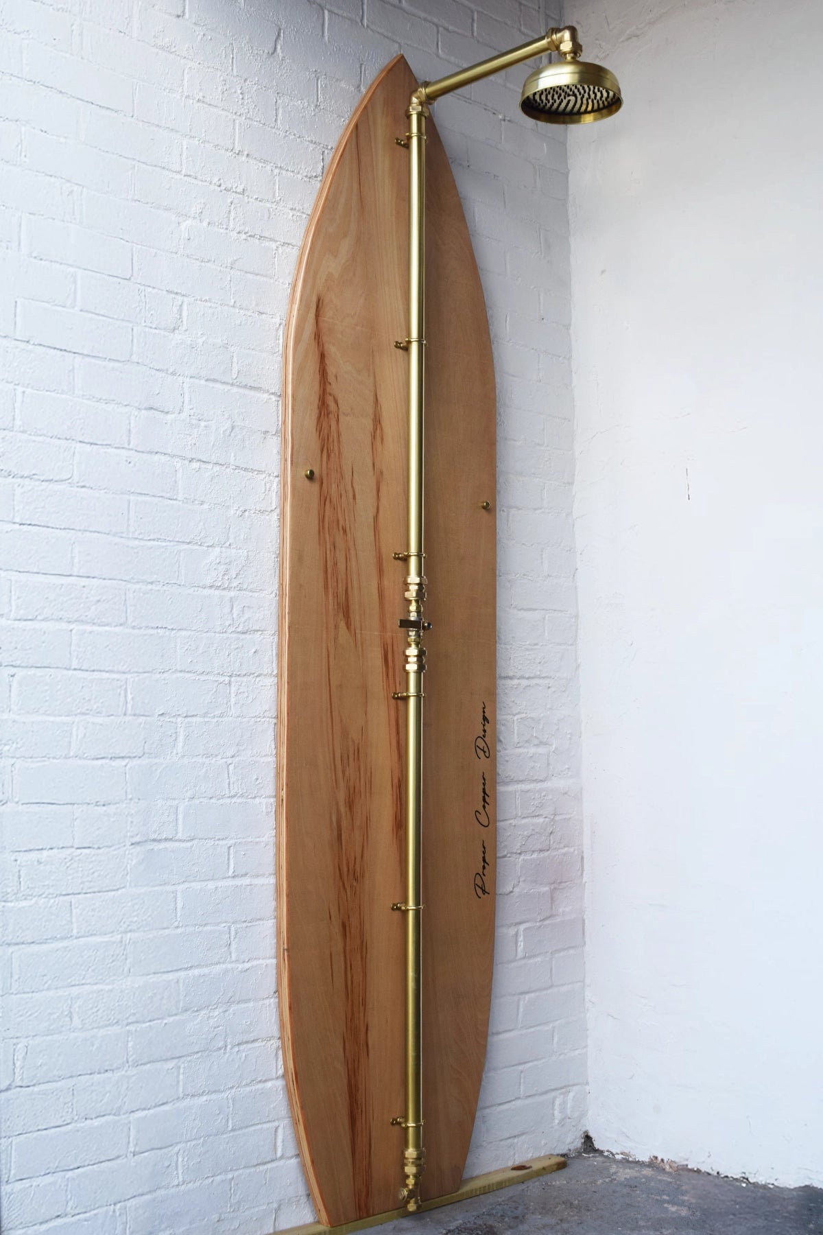 Brass shower on wooden surfboard