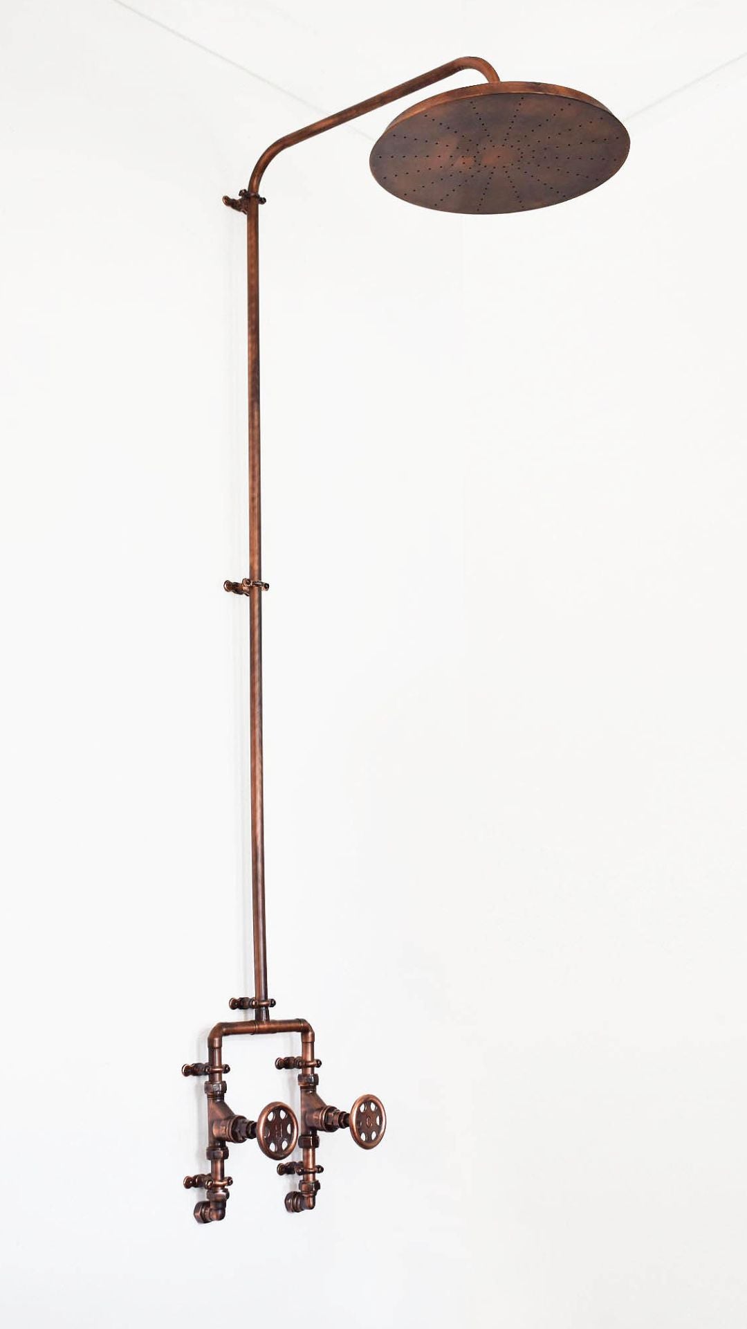 Antique copper shower for indoor or outdoor use photographed on a white background