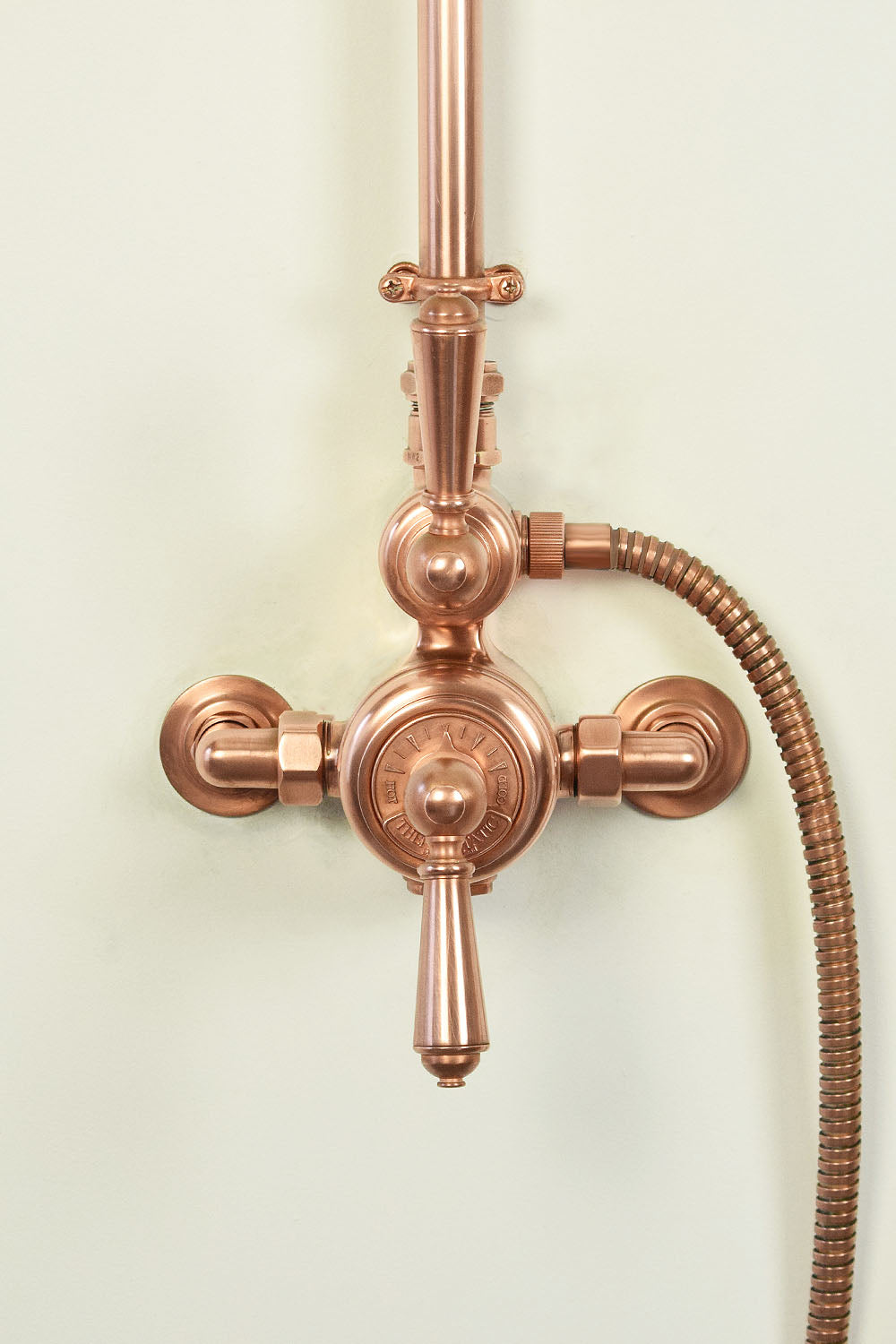copper thermostatic dial on a exposed shower