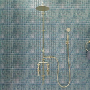 Brass Seducto shower on blue tiles