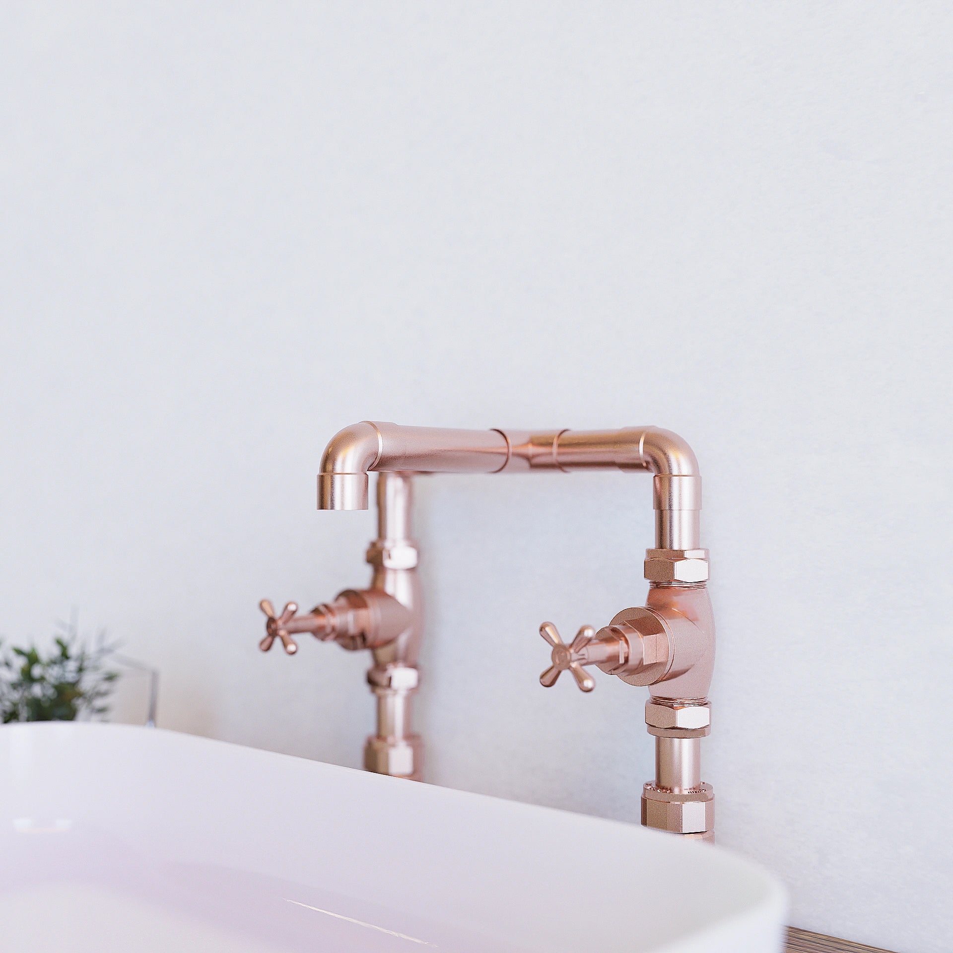 Copper tap in bathroom against white wall