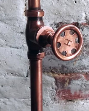 Copper garden with a valve on a textured wall background