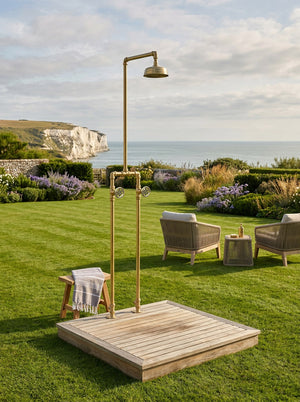 Outdoor free-standing shower setup in a garden with ocean view