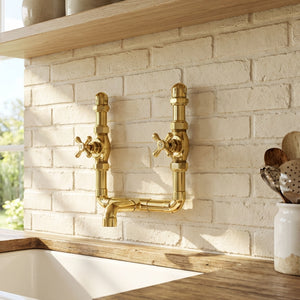 brass kitchen faucet on a brick wall with wooden shelves and utensils.