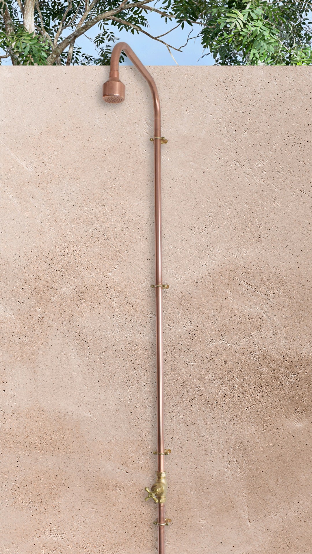 wall mounted copper shower photo of Iriga against a plastered background