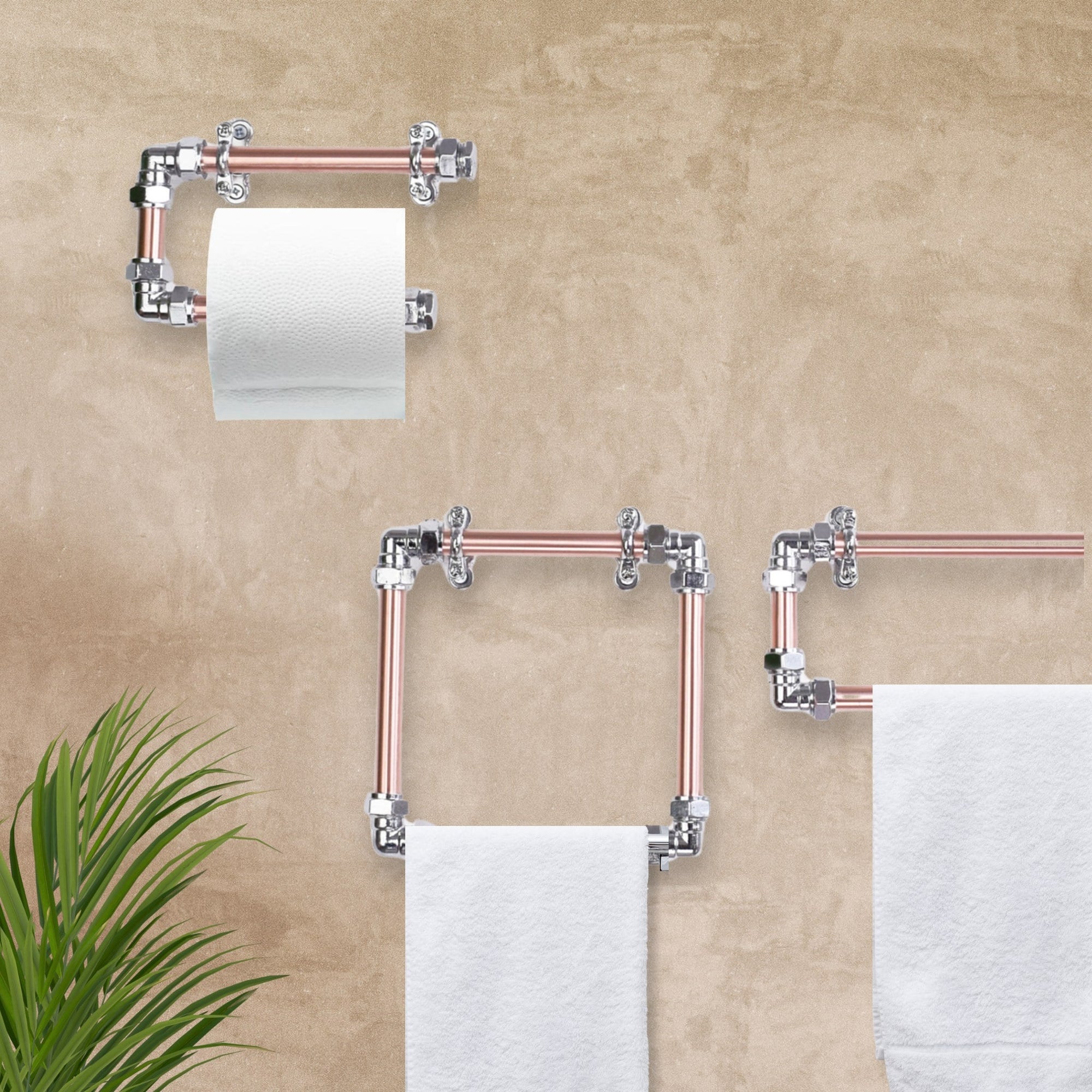 Bathroom setup with copper pipe towel racks and toilet paper holder against a beige wall.