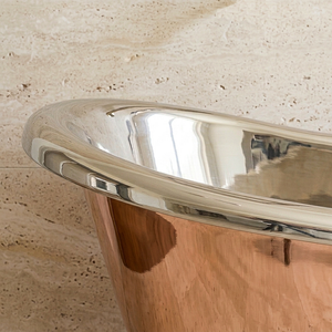 Close-up of a metallic object on a textured beige surface