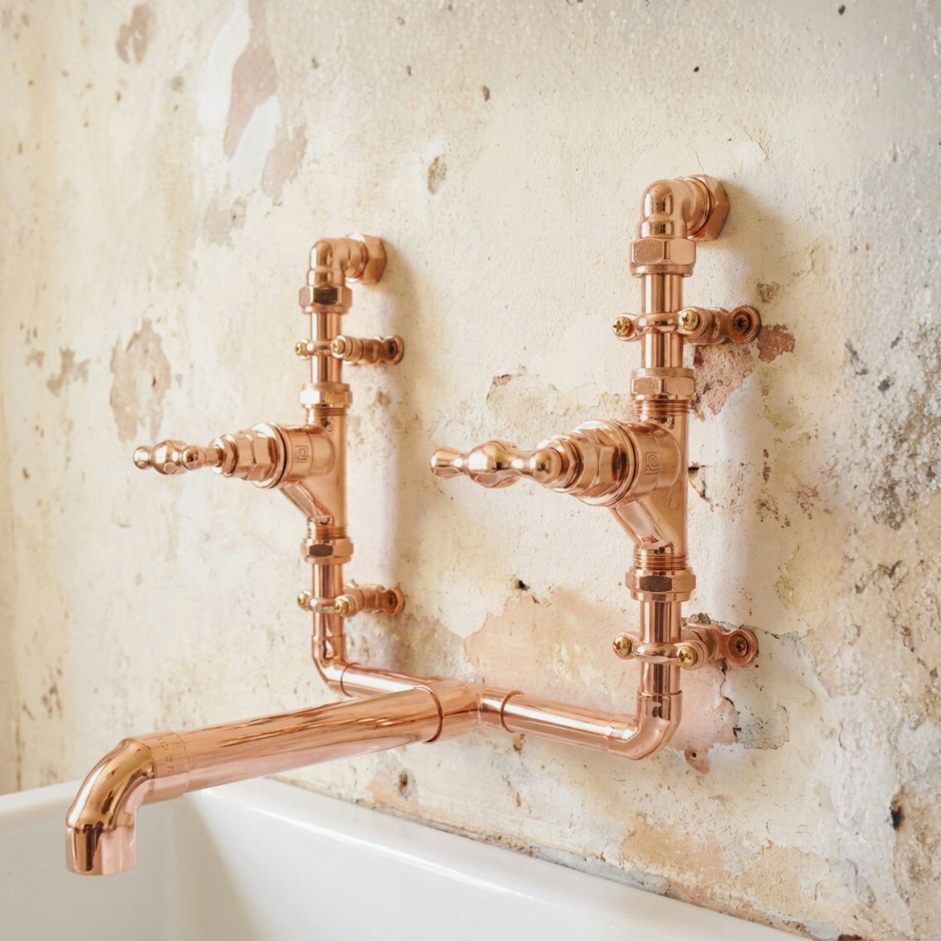 Brass faucet tap mounted on a textured wall farmhouse vintage