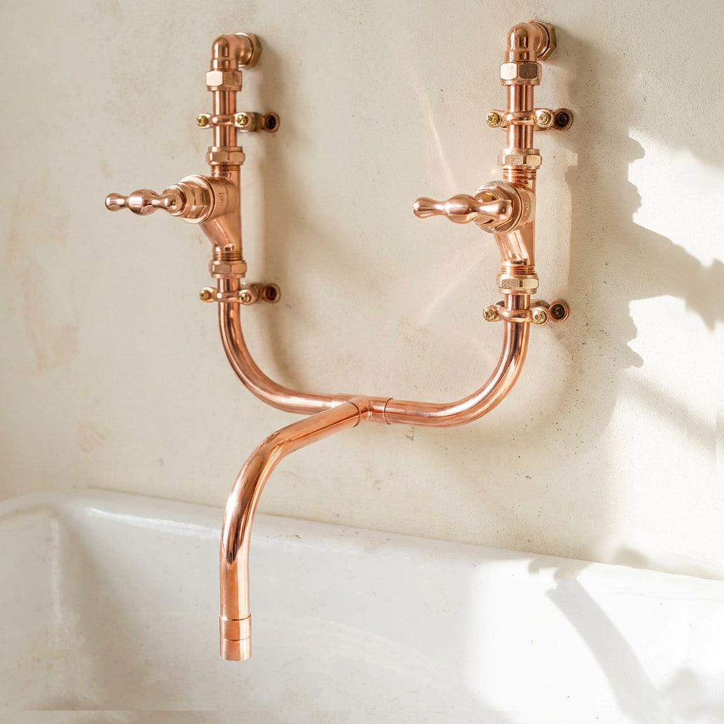 copper wall-mounted faucet tap on a light stone background