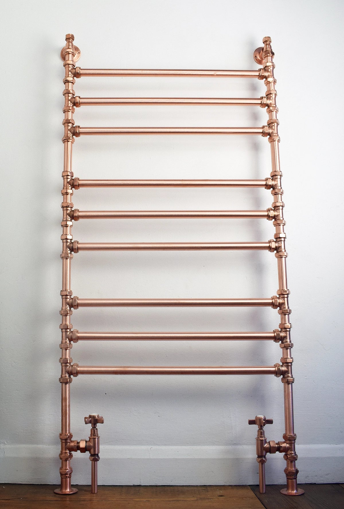 Copper heated towel ladder in bathroom