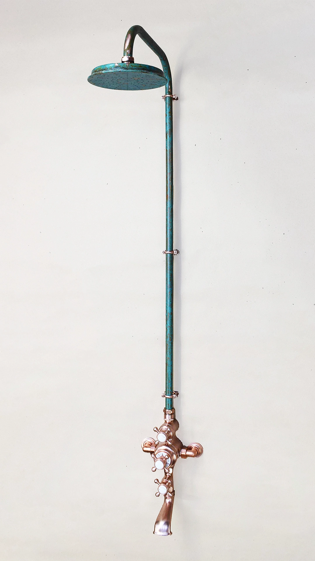 Stylish bathroom thermostatic shower with bath filler in a sleek verdigris copper finish