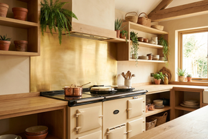 Kitchen splashback brass with a vintage-style stove, wooden shelves, and potted plants, natural brass