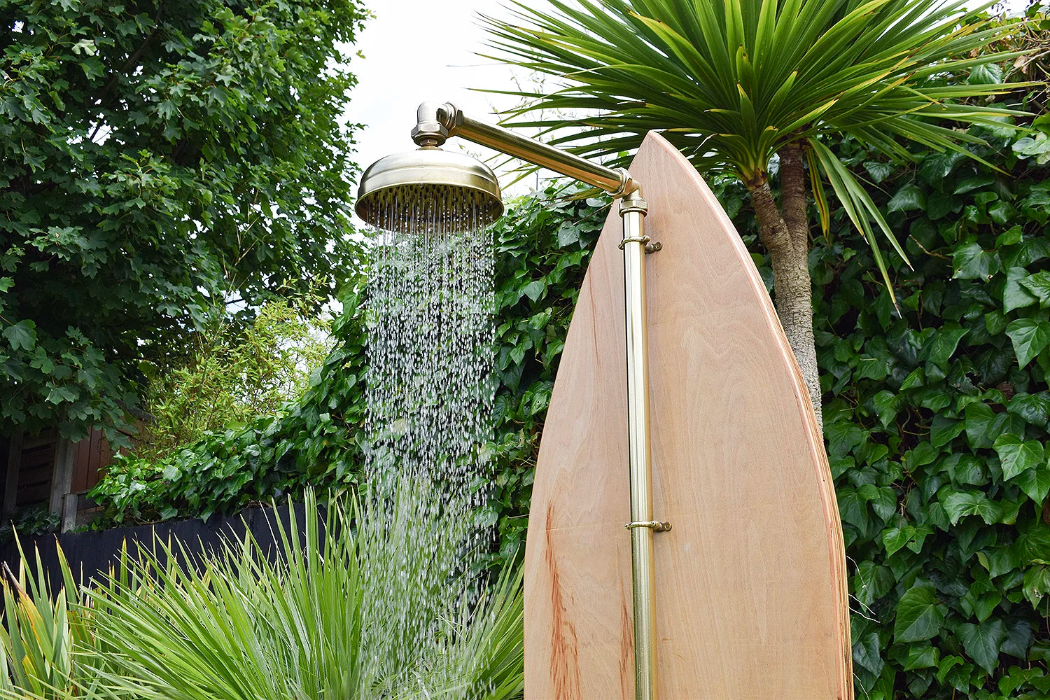 Brass shower against green backdrop