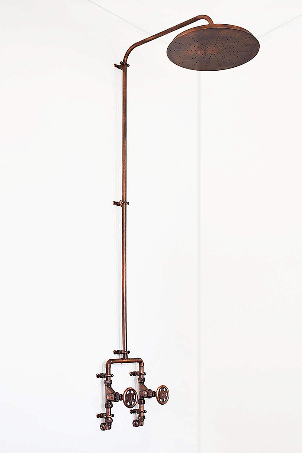 Aged copper shower against white background