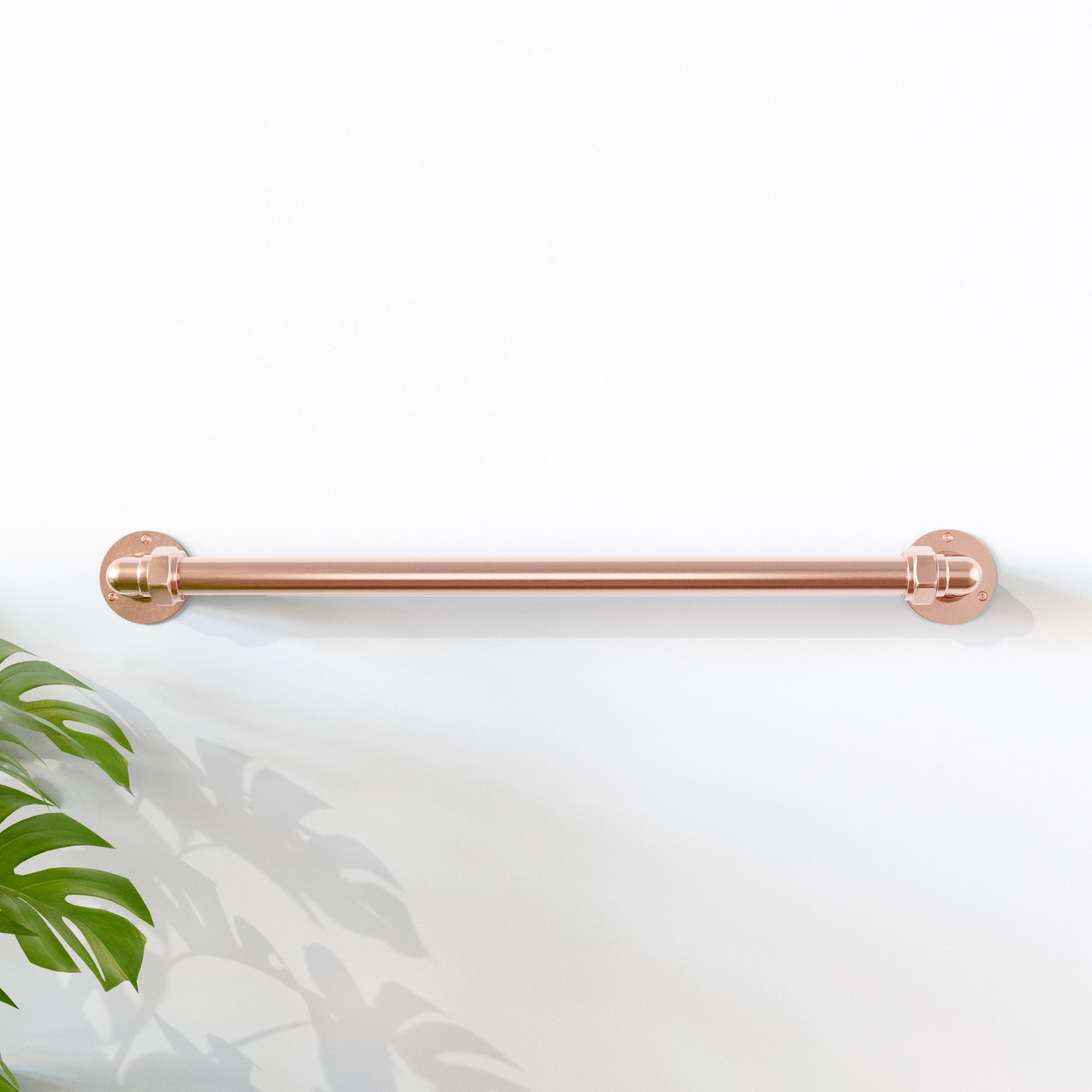 Copper towel rail on white wall