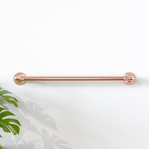 Copper towel rail on white wall