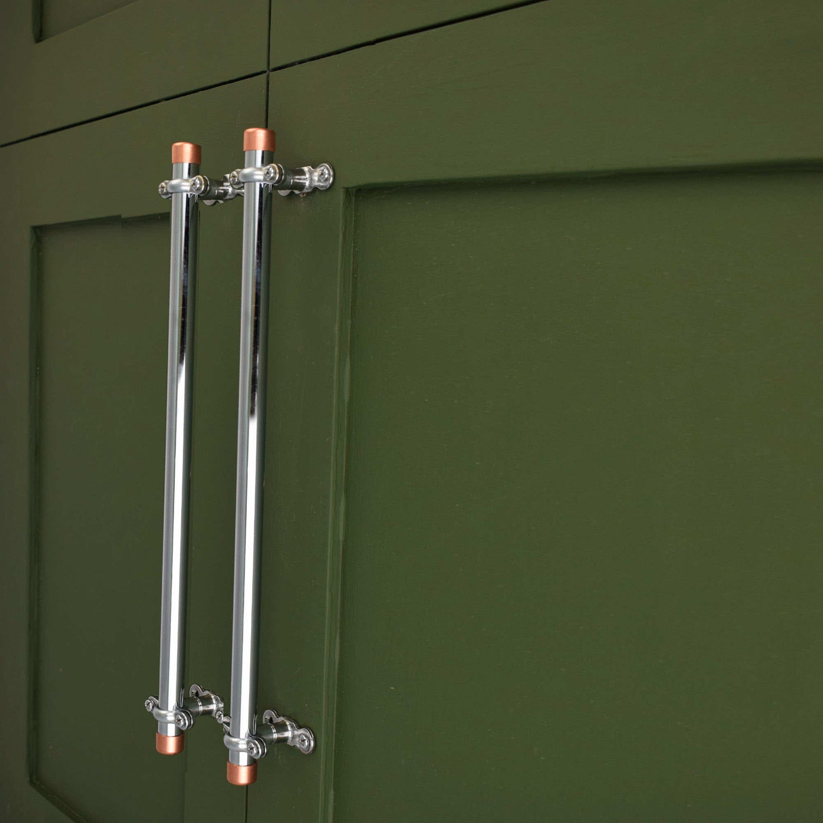 Chrome Bracket handle with Copper End Caps on green cabinets - Proper Copper Design