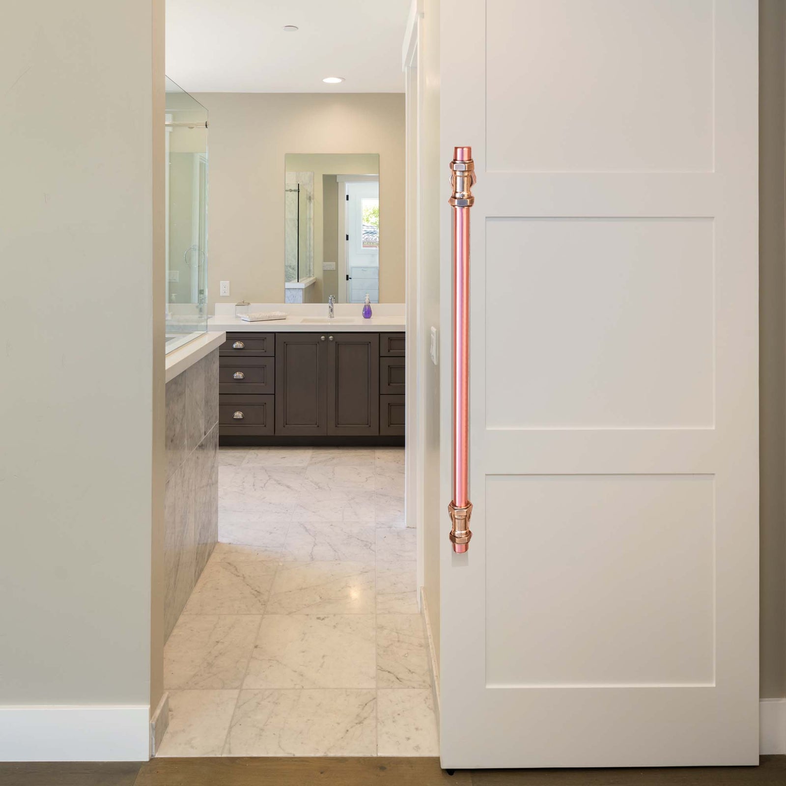 Copper and brass industrial door handle on sliding door