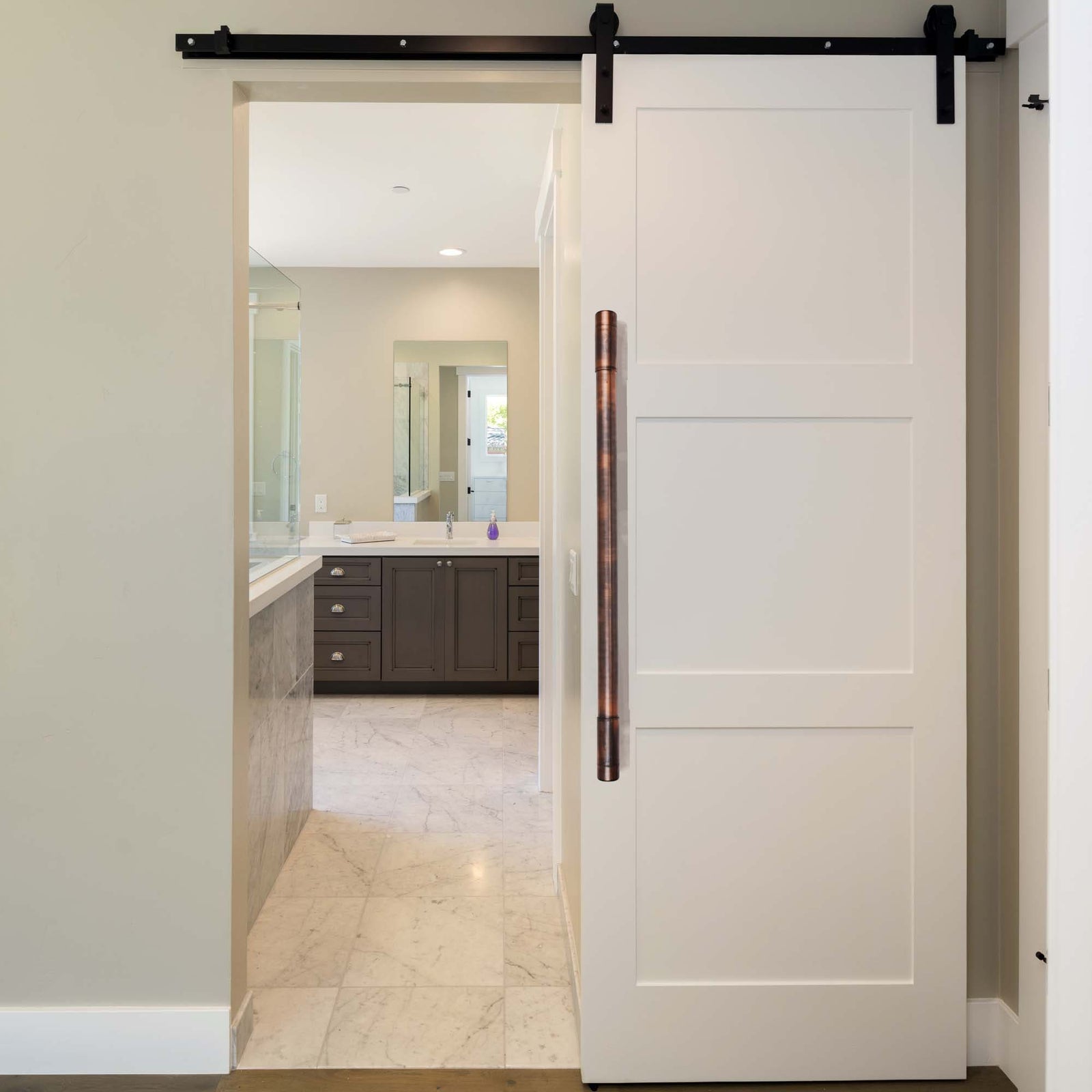 aged copper pull on white barn door