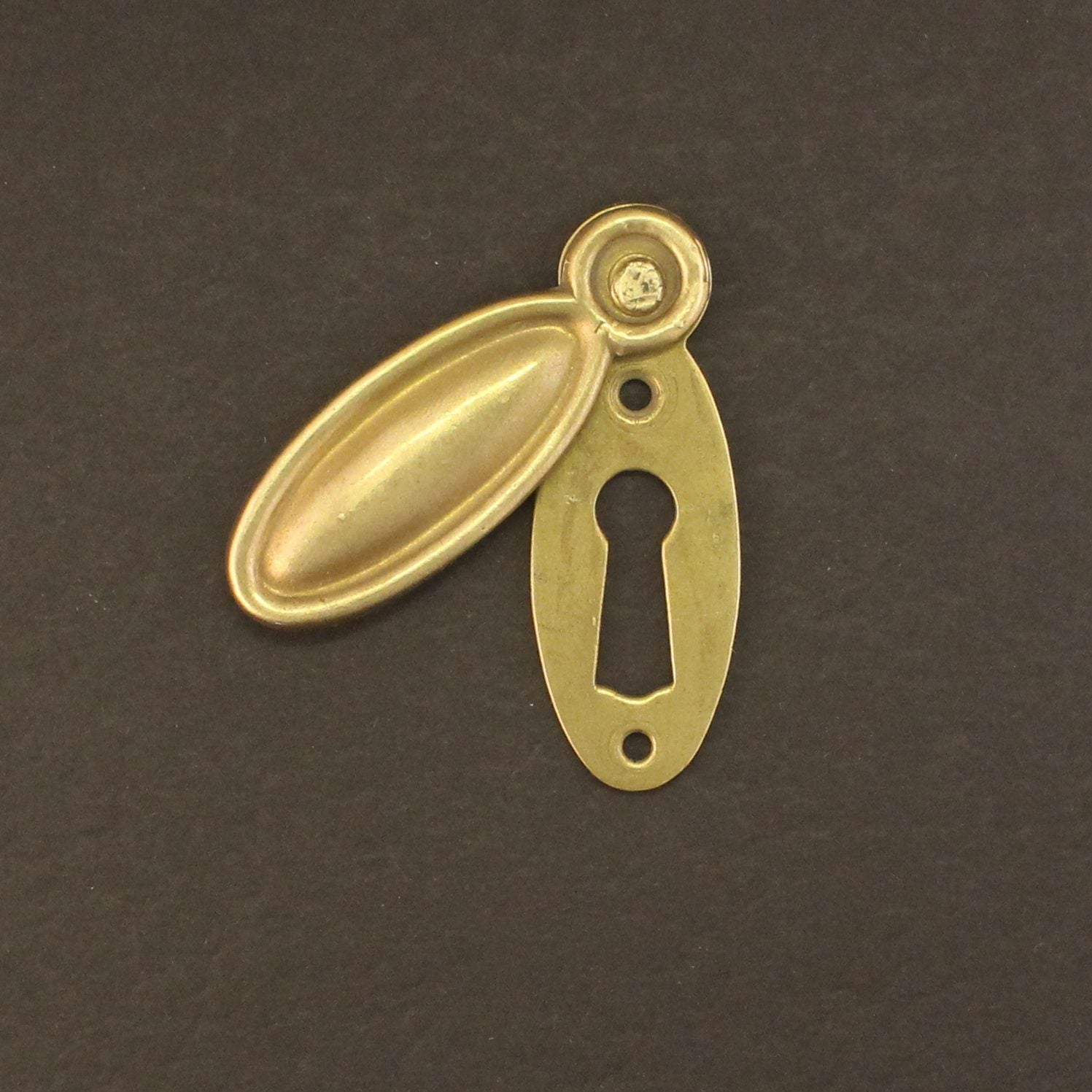Solid brass escutcheon on black background