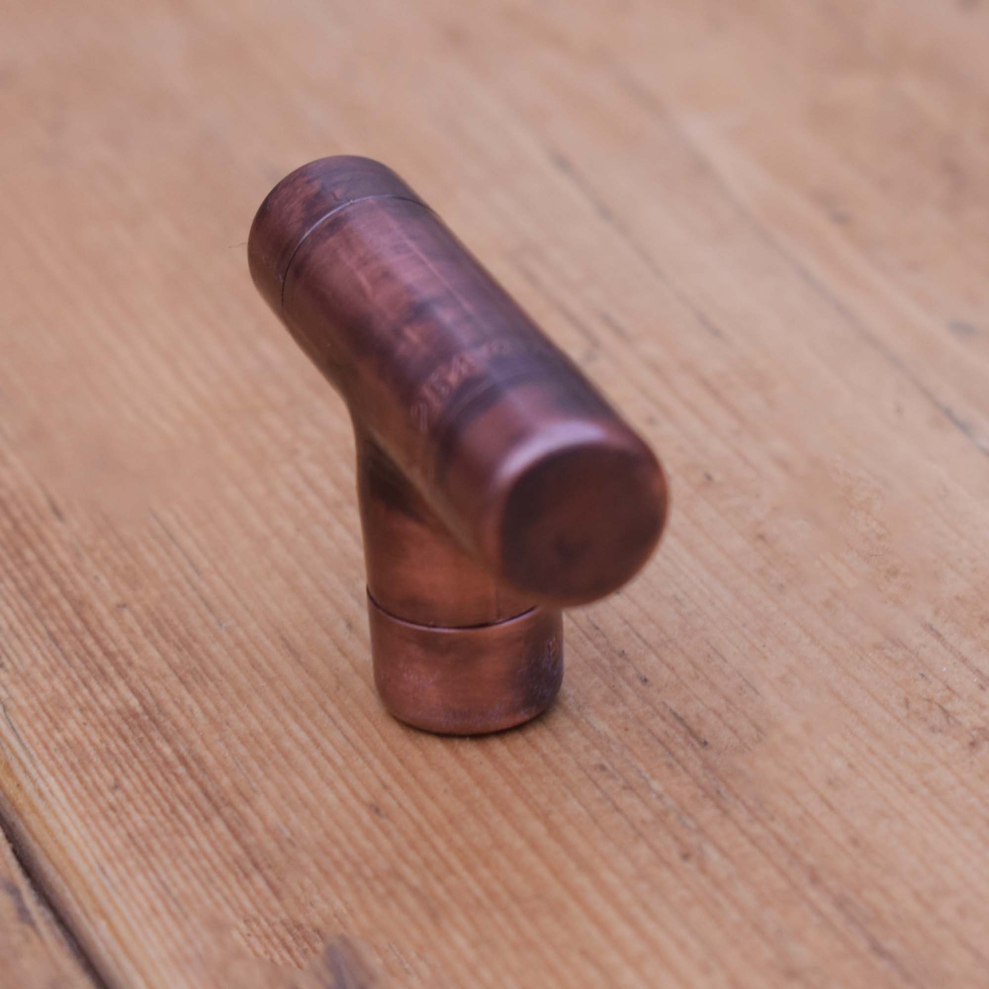 Aged Copper T-Knob on Wooden Cabinets