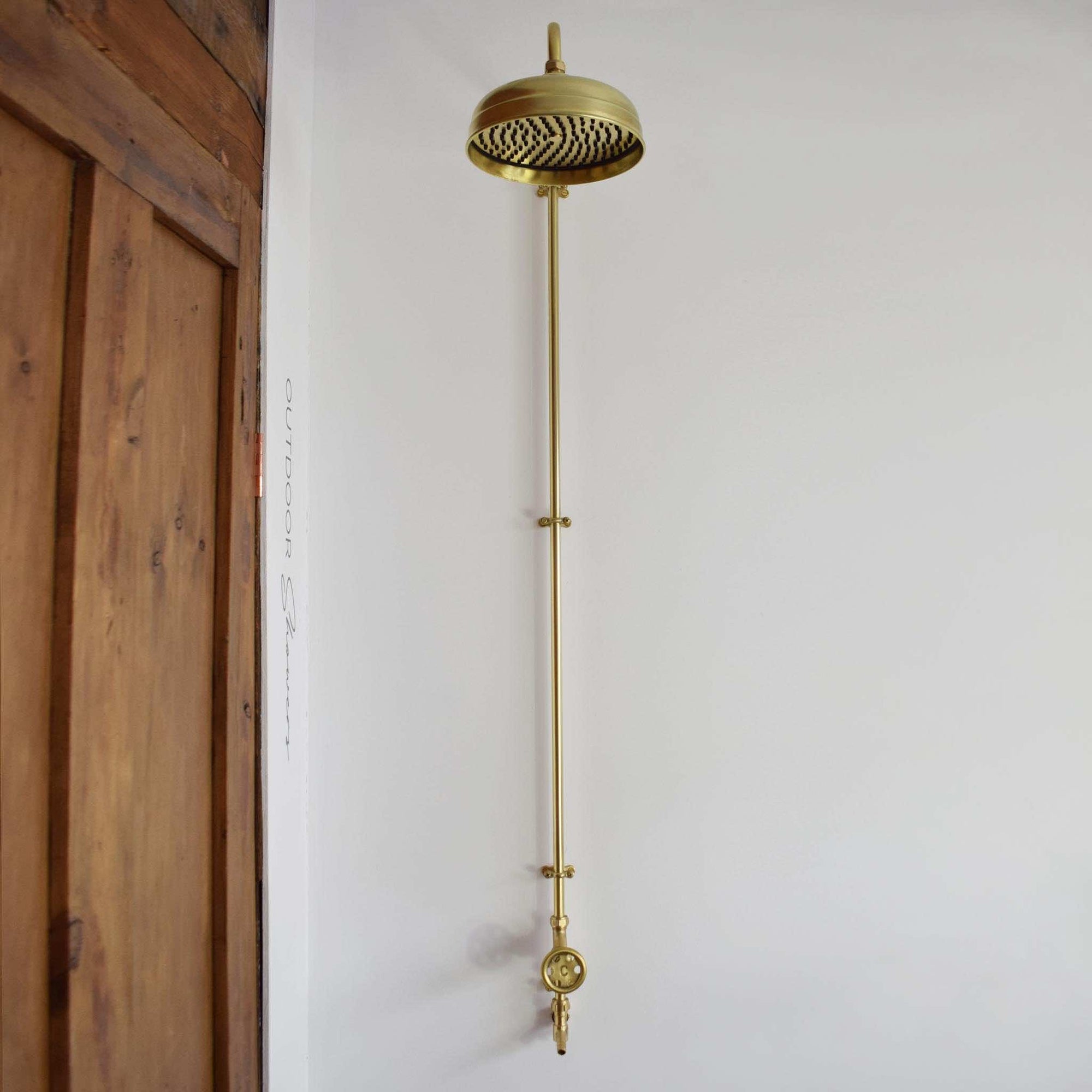 photo of a brass shower on a white background perfect for garden showering