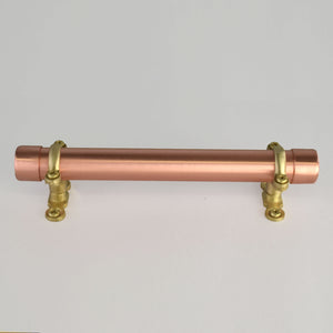 brass and copper bracket pull on white