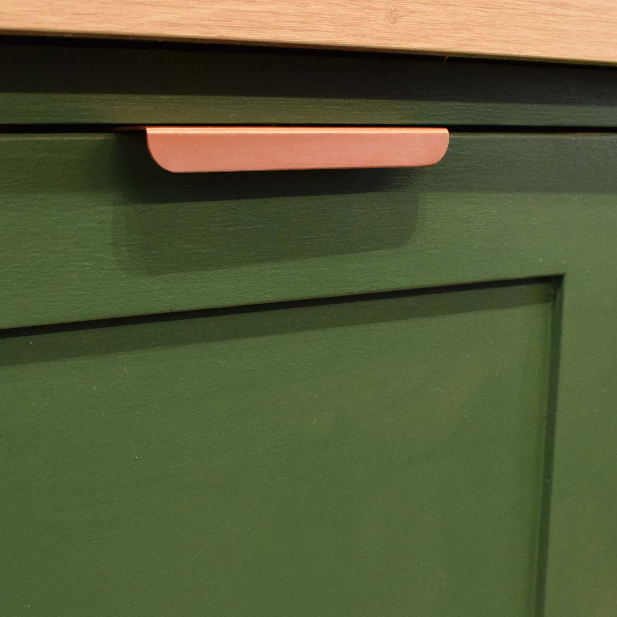 Folded Copper Lip Pull - On Green Cabinets Angled
