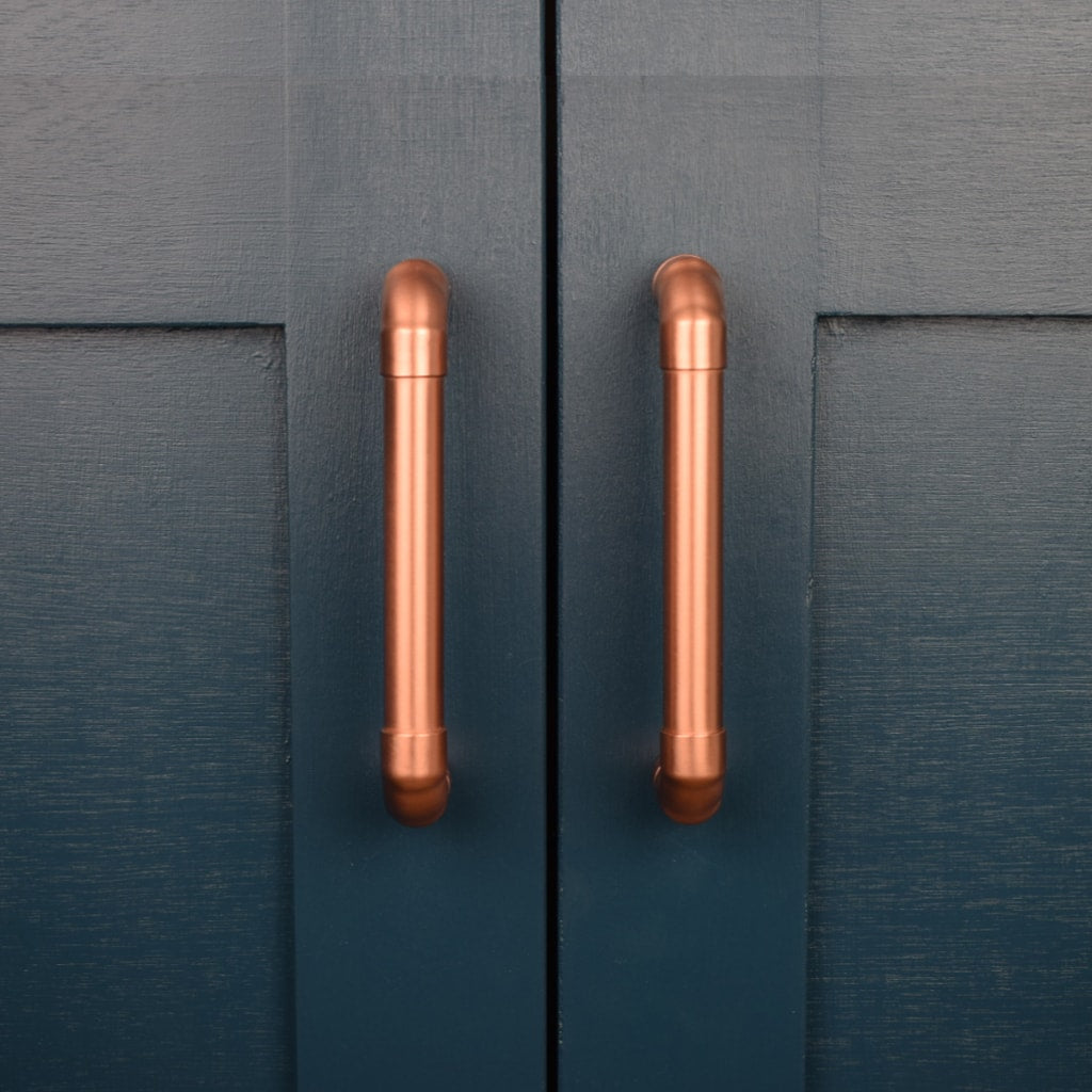 Copper Handle on blue cabinet front shot