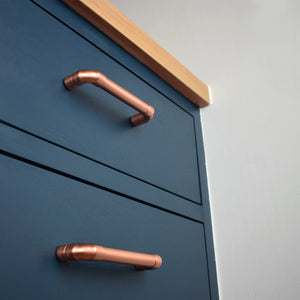 Copper Handle on blue cabinet