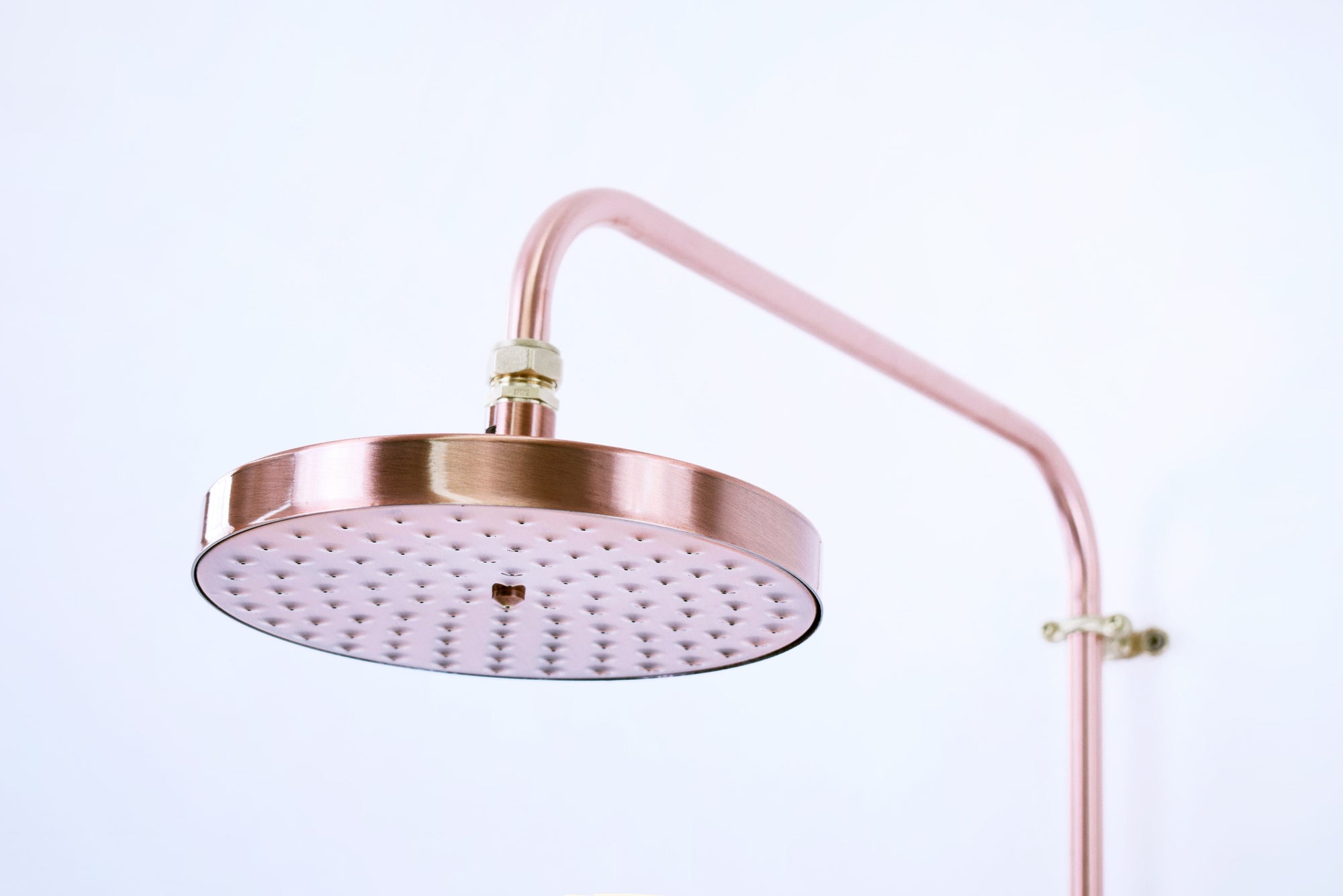 close up image of a copper shower head available in our bathroom shop