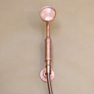 Sleek copper outdoor shower with a modern design and a helpful and stunning hand-shower attachment