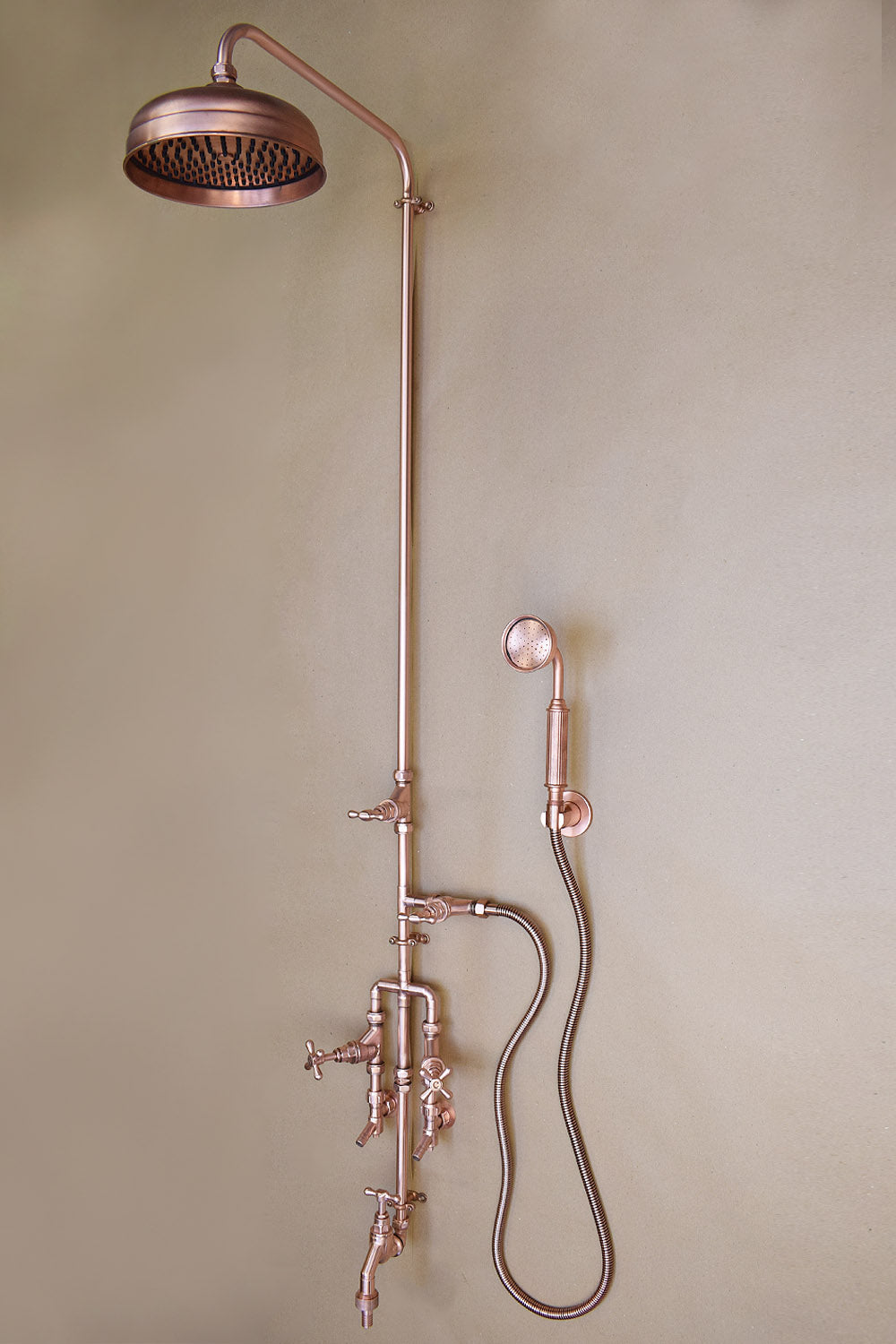 new fully copper outdoor shower design with a mix of industrial and natural elements