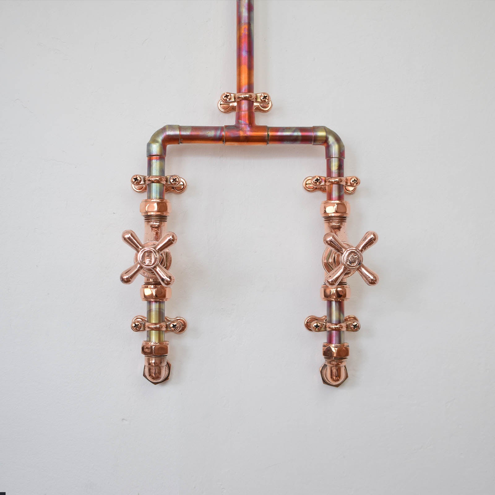 High-polish crosshead tap turns on the Marbled Copper Mixer Shower Marblista.