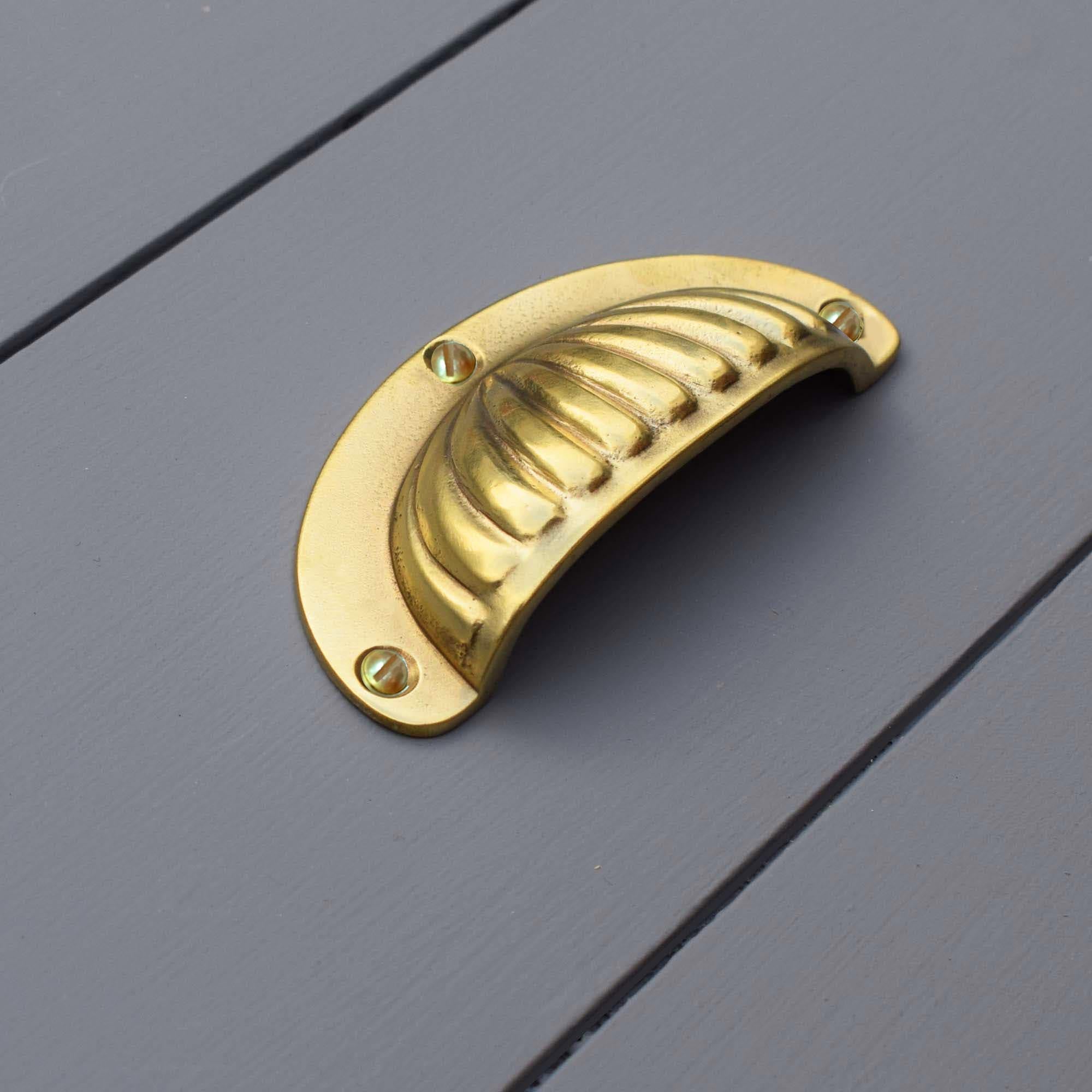 Brass Scalloped Cup Handle - On blue drawers