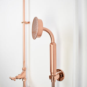 Luxurious outdoor pool shower with copper accents