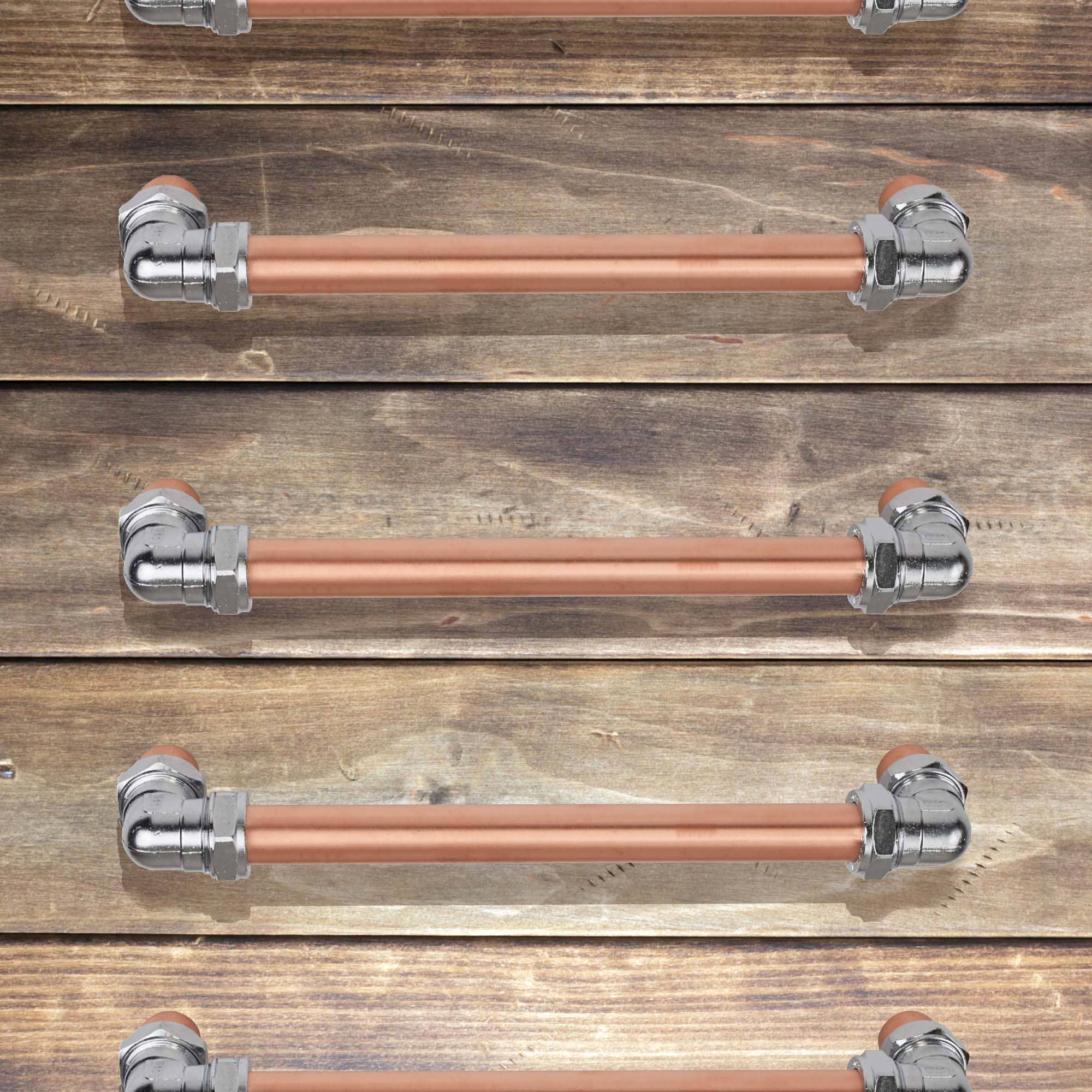 Chrome and copper barn door handle on wooden drawers