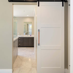 Chrome and copper barn door handle on modern sliding bathroom door