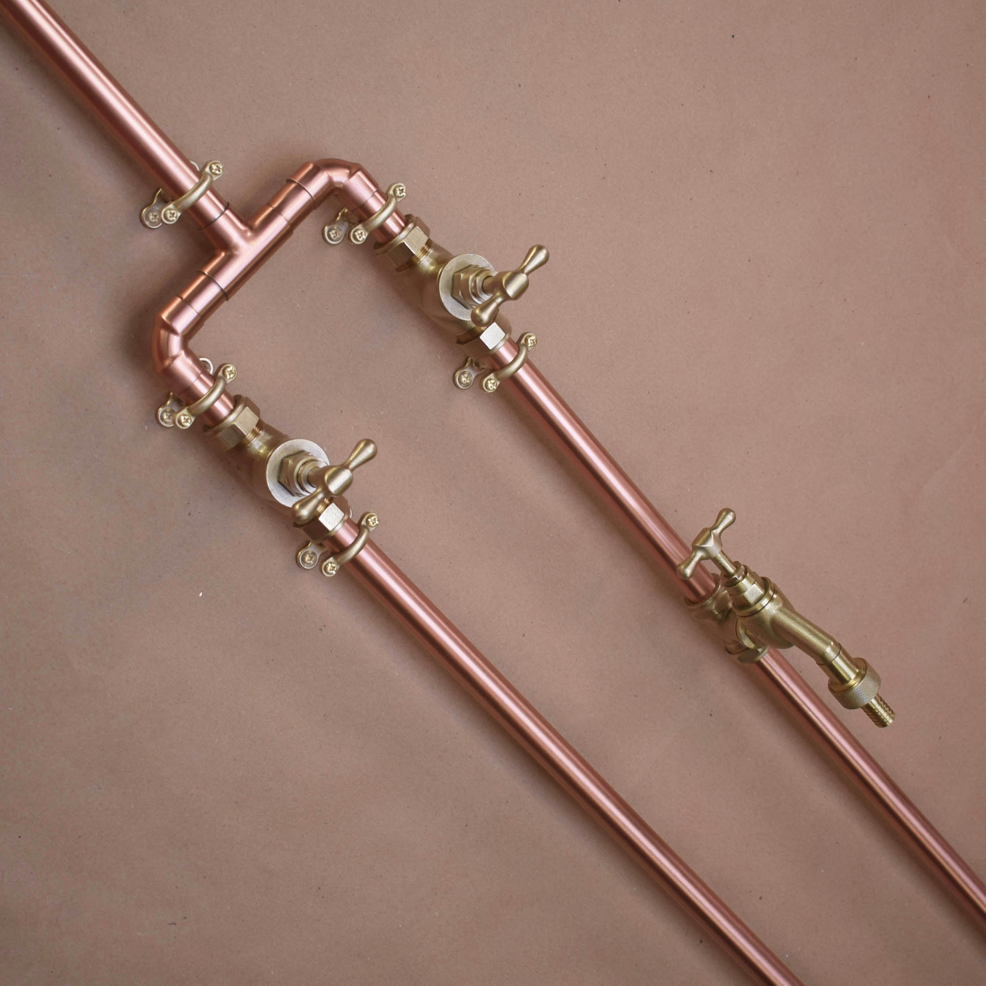 close up image of the polished copper on the poolside shower