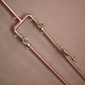 close up image of the polished copper on the poolside shower