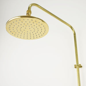 A low-profile flat shower head with a minimalist design and a soothing mist spray pattern for a spa-like shower experience in brass
